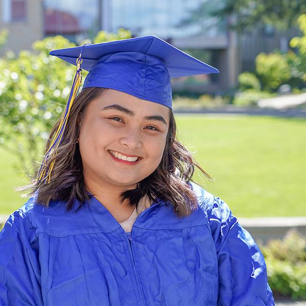 grad wearing blue regalia